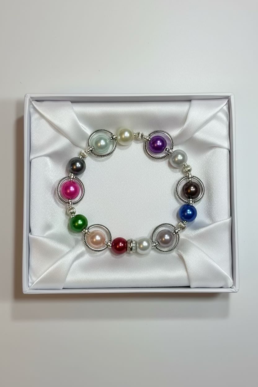 Multicolored beaded bracelet in a white box on a light gray background