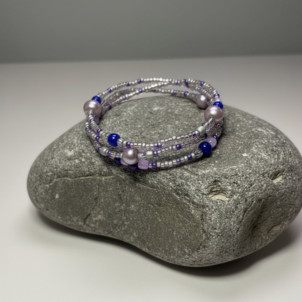 Purple beaded bracelet on a large grey stone