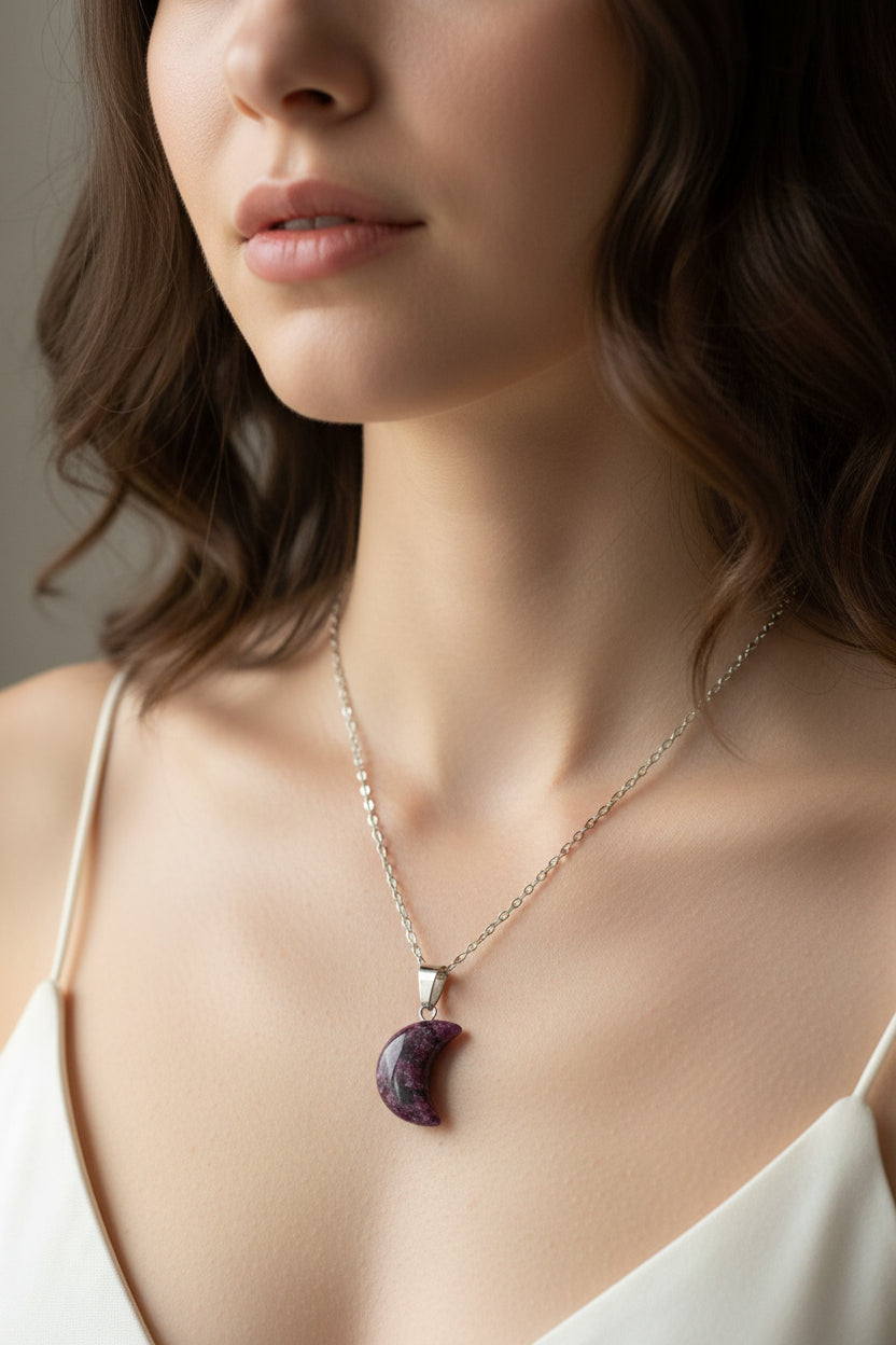 Necklace with a purple moon pendant on a model 