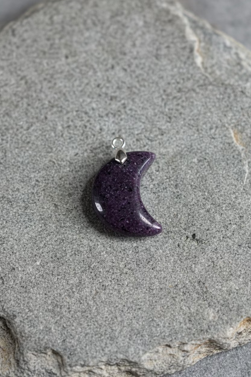 Crescent moon-shaped pendant on a light gray background