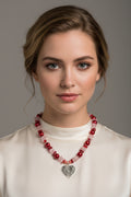 Beaded necklace with a heart charm on a model
