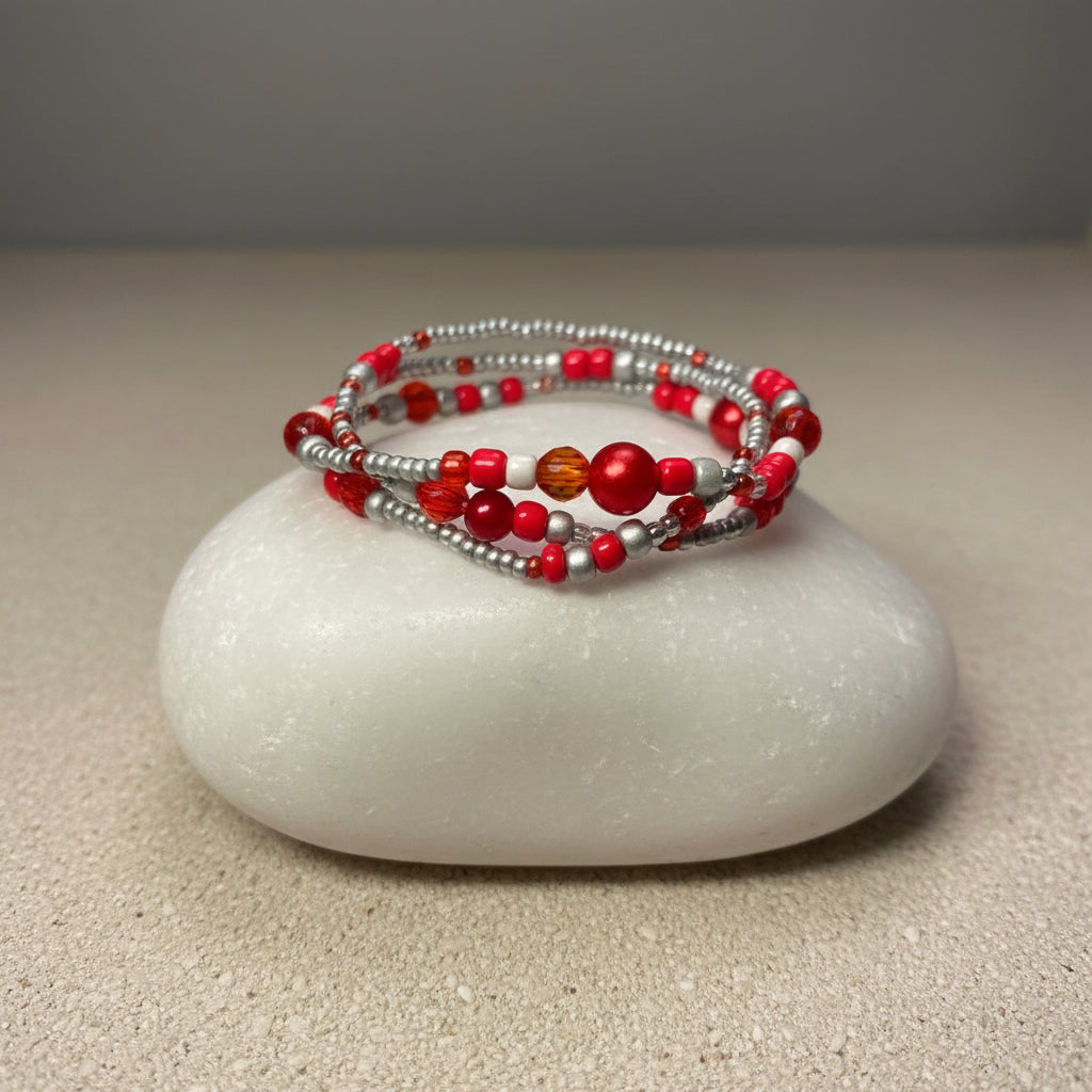 Beaded pearl triple bracelet set with red and silver beads on a large white stone
