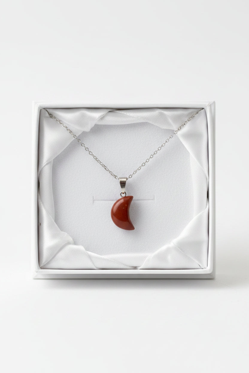 Necklace with a red pendant in a white gift box
