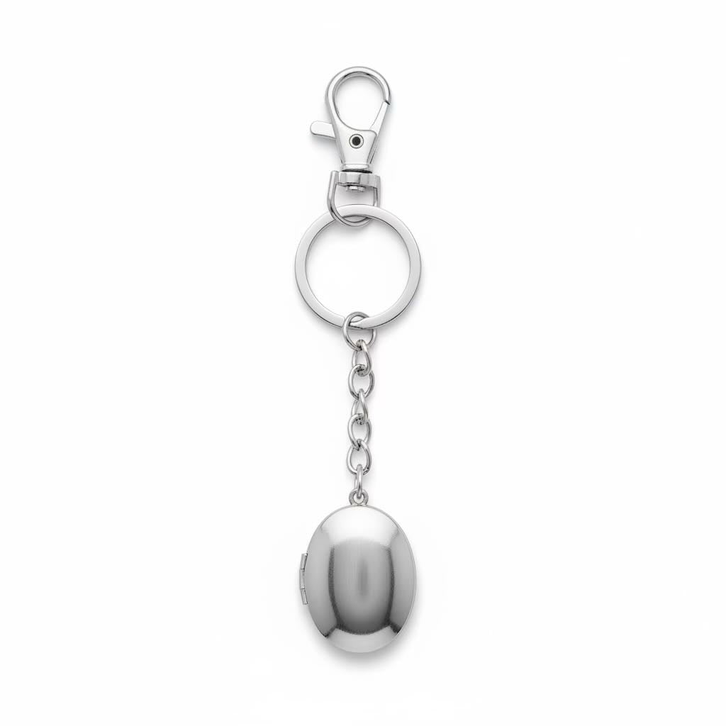 A polished silver metal keychain featuring a lobster clasp, a split key ring, a short chain, and a hanging oval locket pendant, shown on a plain white background.