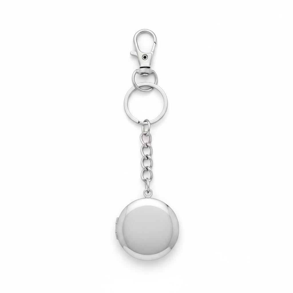 A silver-toned metal keychain featuring a flat circular locket pendant, a short chain, a split key ring, and a lobster clasp, shown on a plain white background.