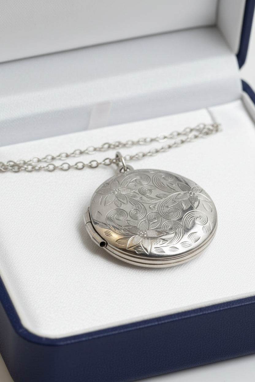 Silver necklace with a round pendant in a blue gift box