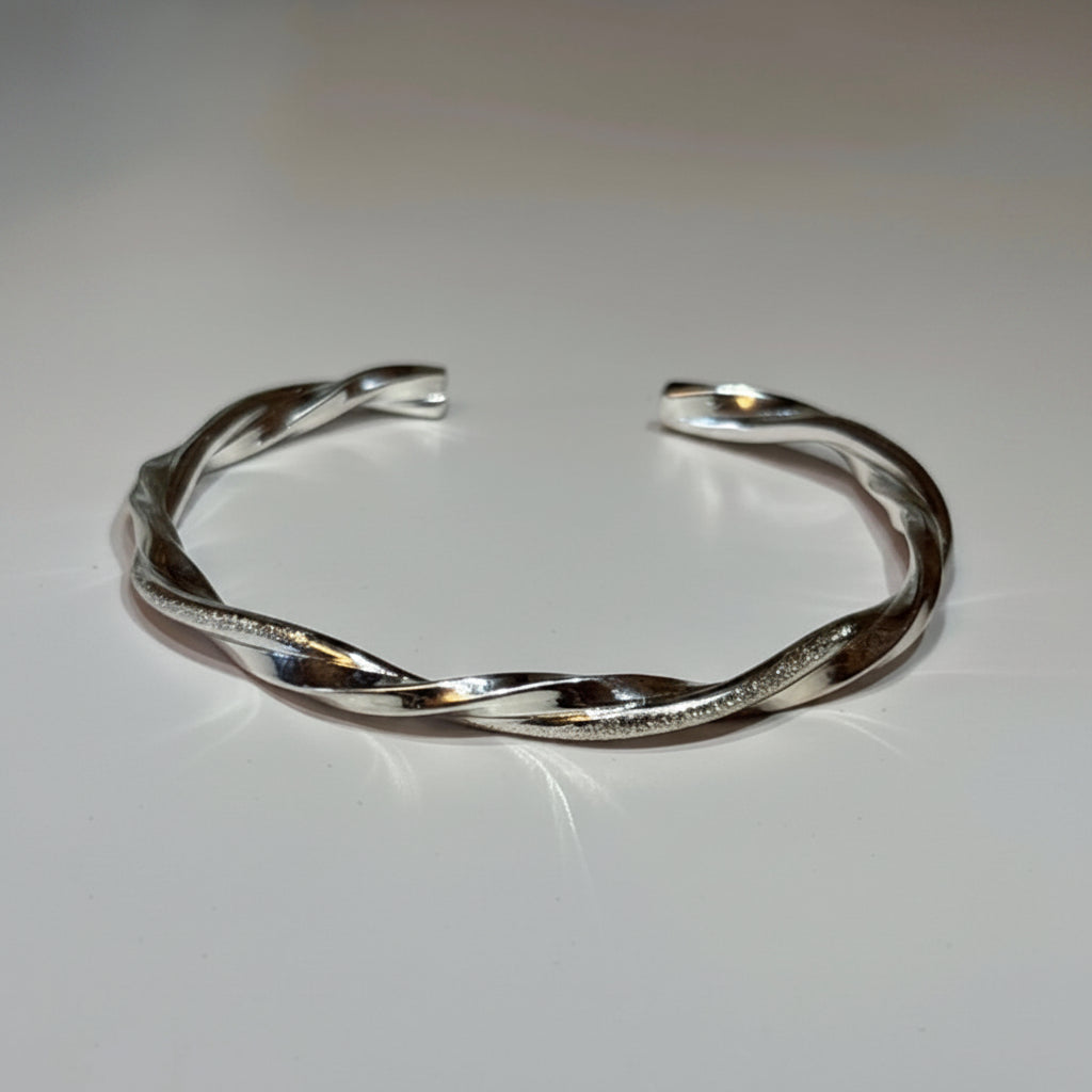 Silver bracelet on a light gray background