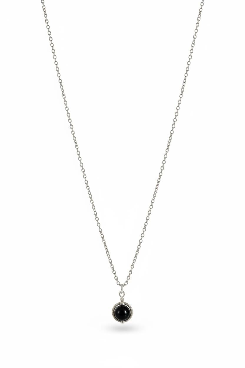 A delicate silver chain necklace with a small round black pearl pendant, displayed against a clean white background.
