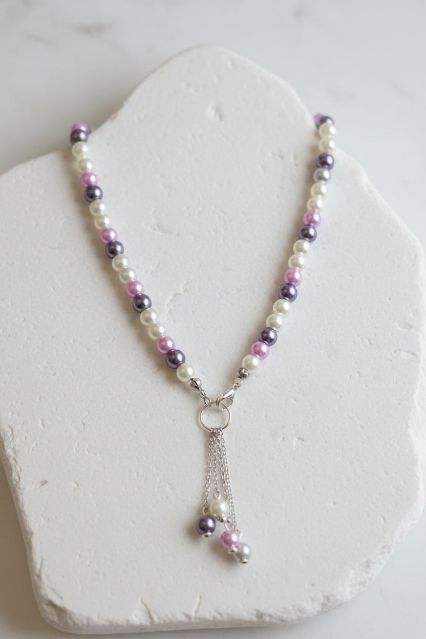 Necklace with multicolored beads and a silver chain on a large white stone