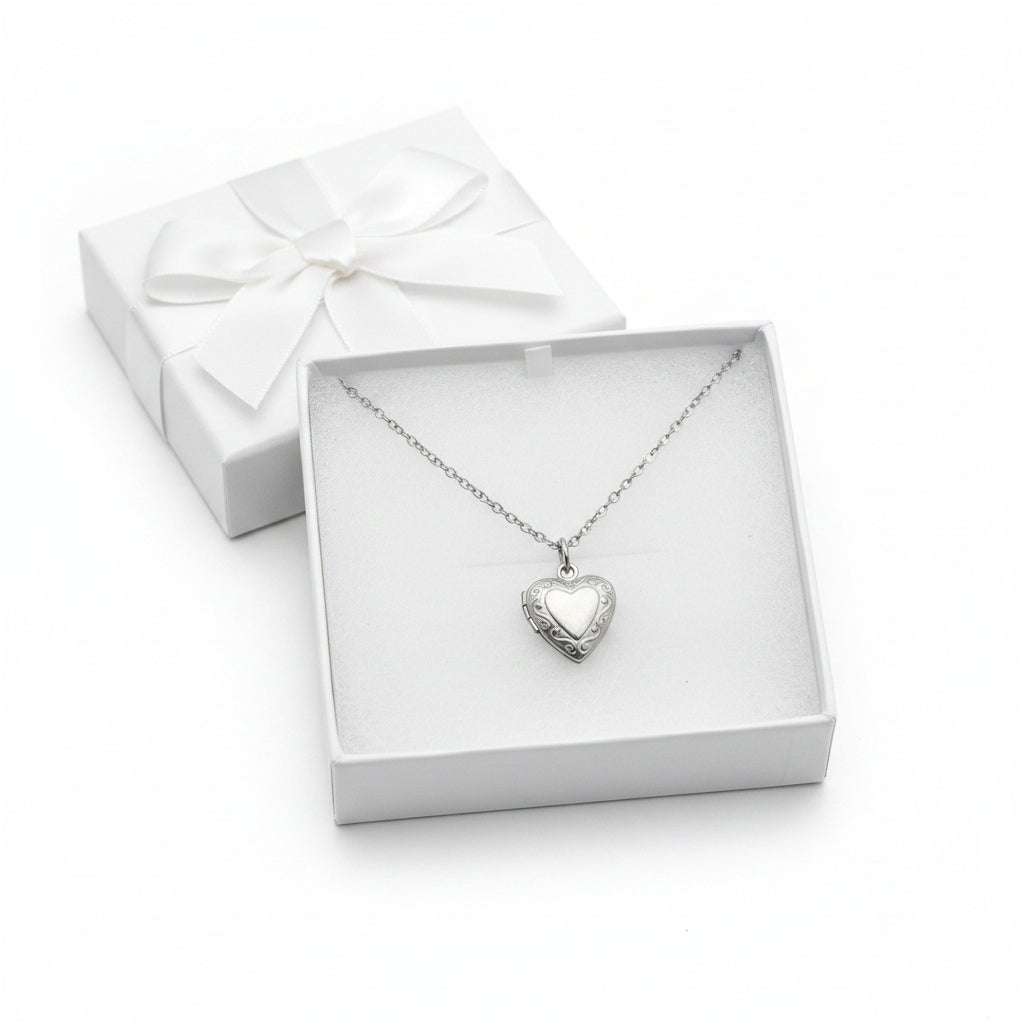 Silver heart-shaped pendant necklace in a white gift box.