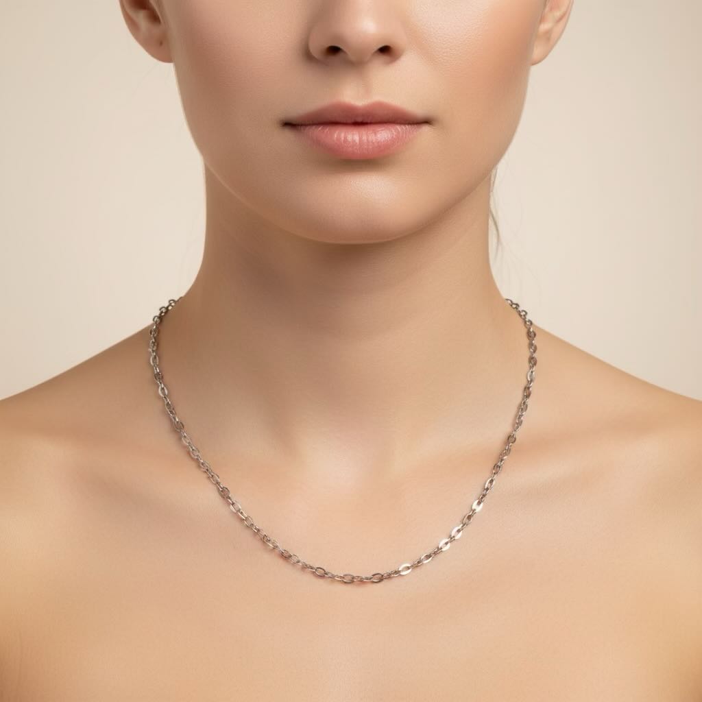 Silver necklace on a model against a neutral background