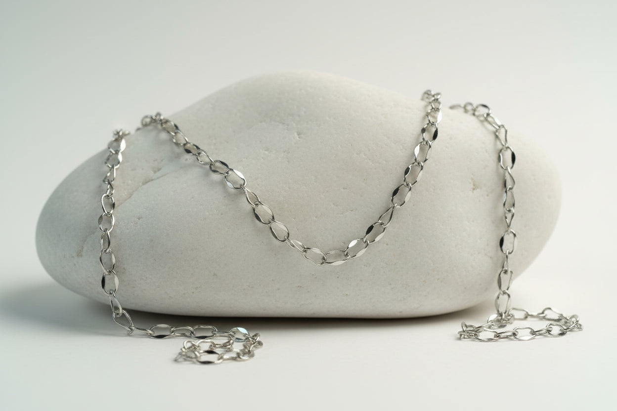 Silver chain necklace on a large white stone