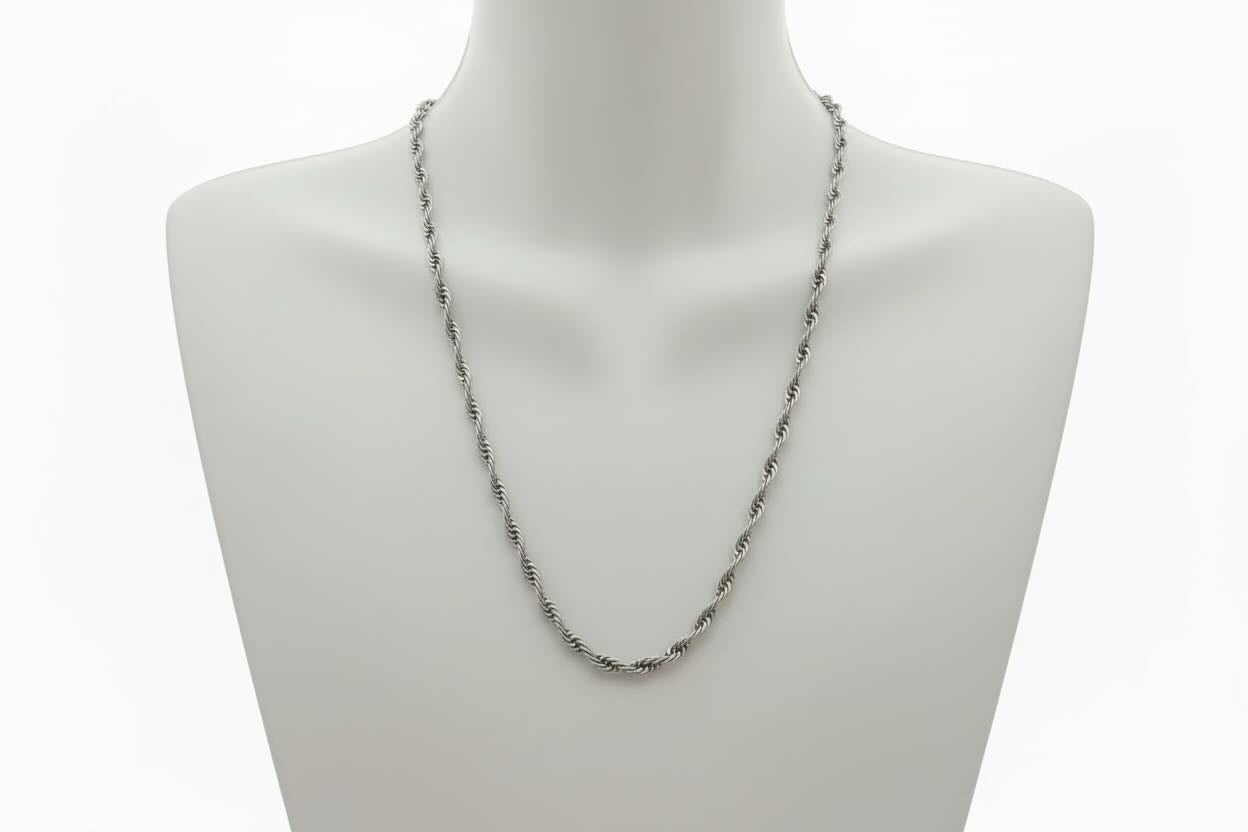 Silver chain necklace on a mannequin bust against a white background
