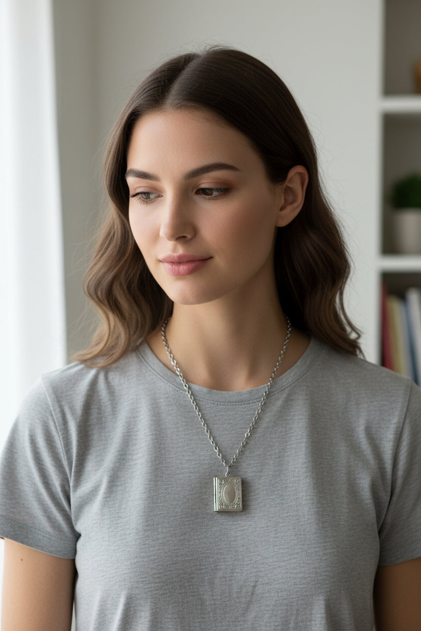 Silver necklace with a book locket pendant on a model