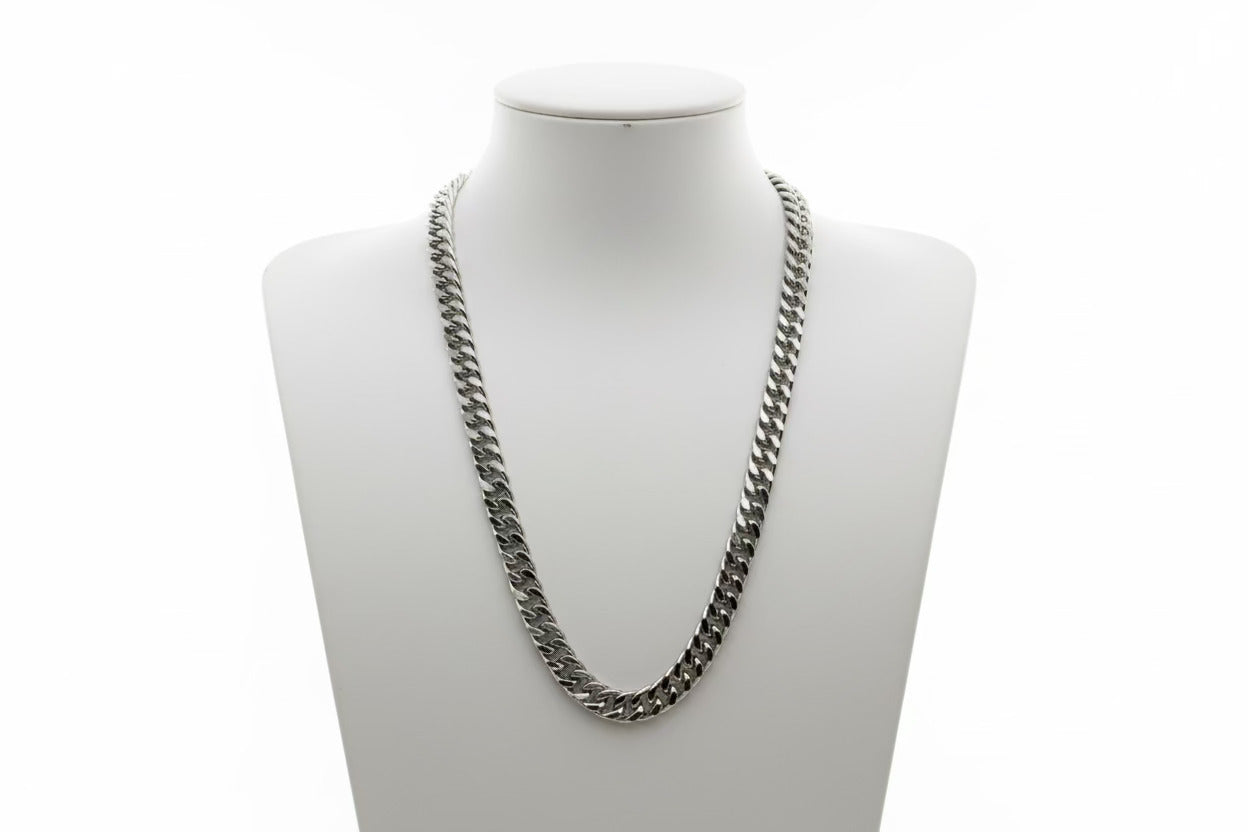 Silver chain necklace on a mannequin bust against a white background