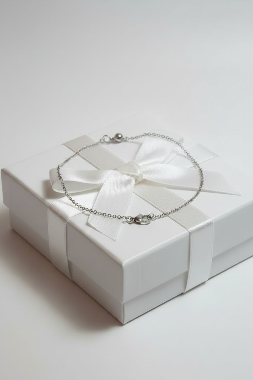 Silver chain necklace on a large gift box