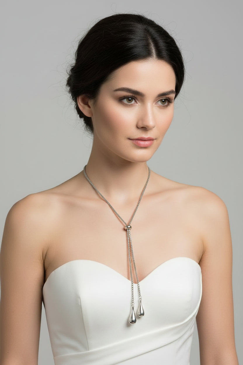 Silver necklace with teardrop pendants on a model