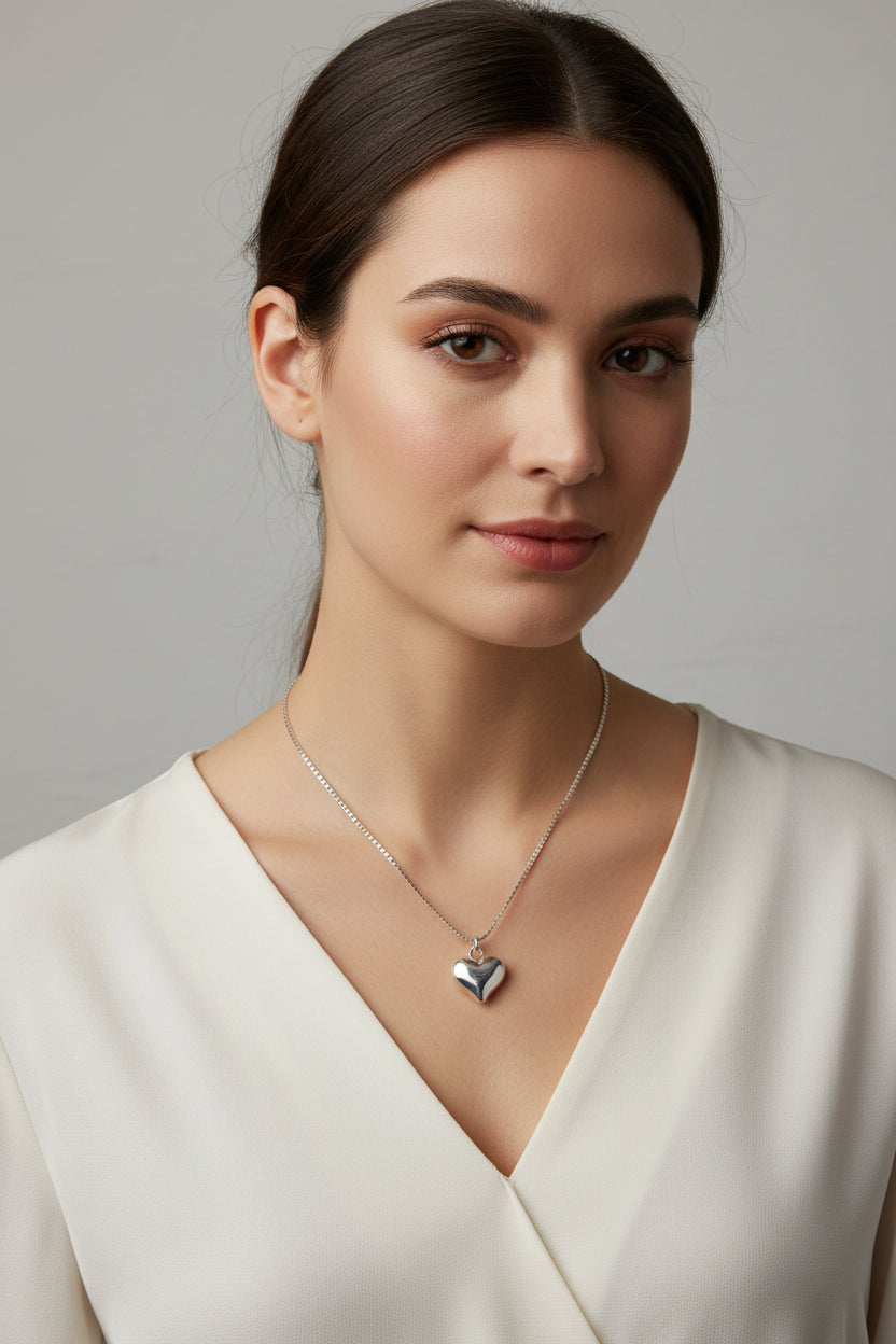 Silver heart-shaped pendant necklace on a model
