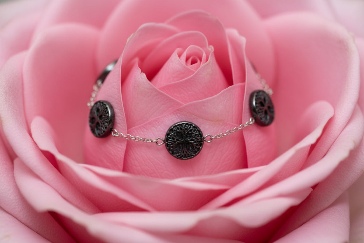 Silver bracelet on a large rose petal