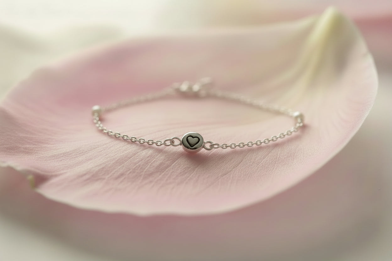Silver bracelet on large pale pink petal