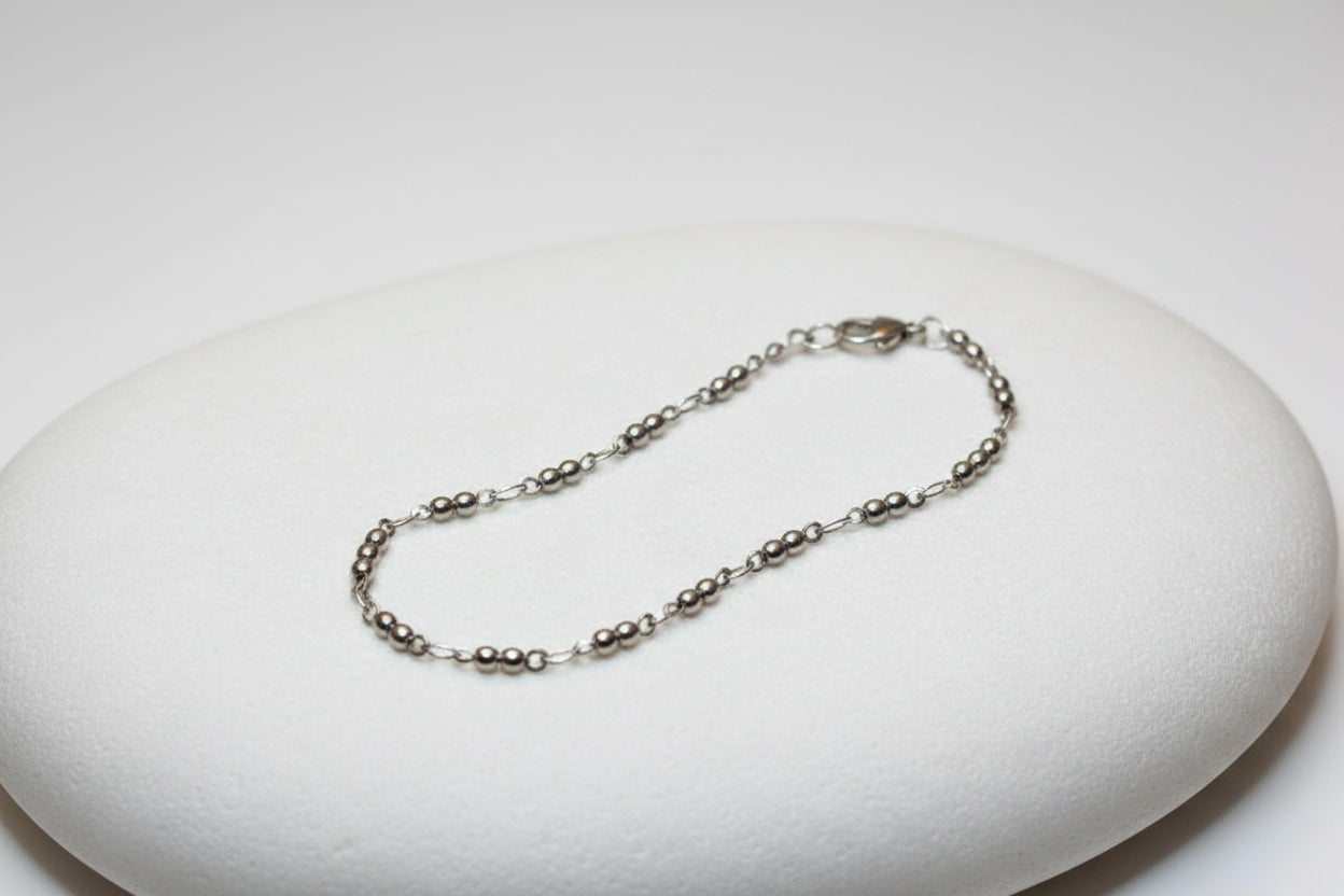 Silver chain necklace on a large white stone