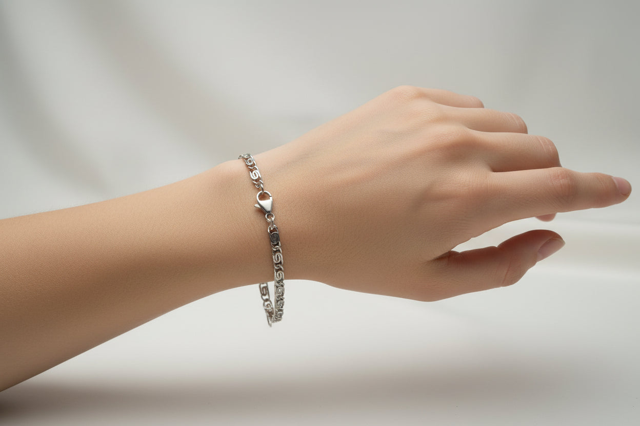 Silver chain bracelet on a model's arm 
