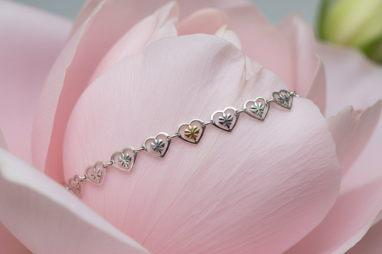Bracelet with heart-shaped charms on a 
large pale pink petal