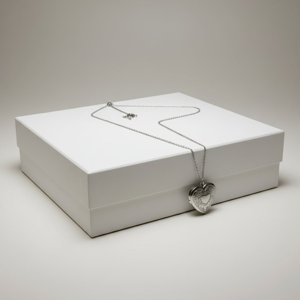 Silver heart-shaped pendant necklace on a gift box