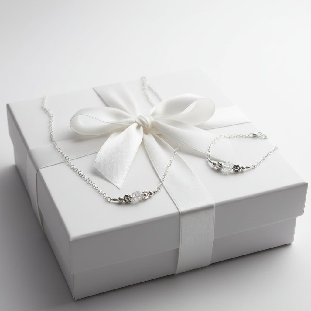 Silver necklace and bracelet set on a gift box