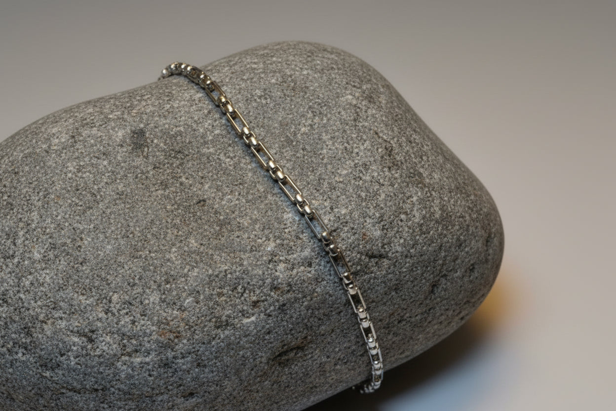 Silver chain bracelet on large grey stone