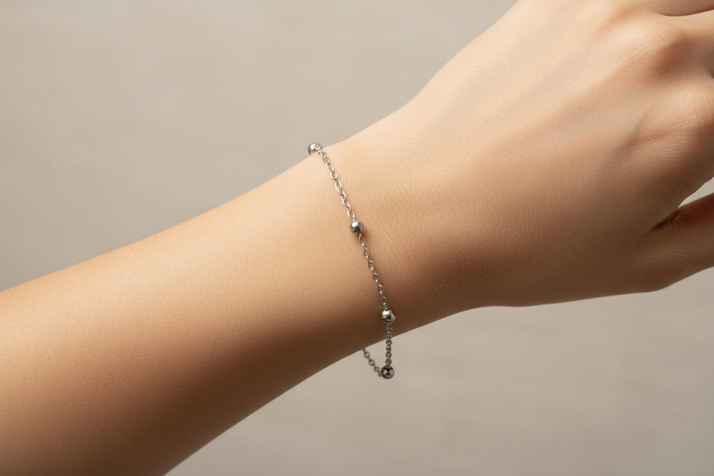 Silver chain bracelet on a model's arm 