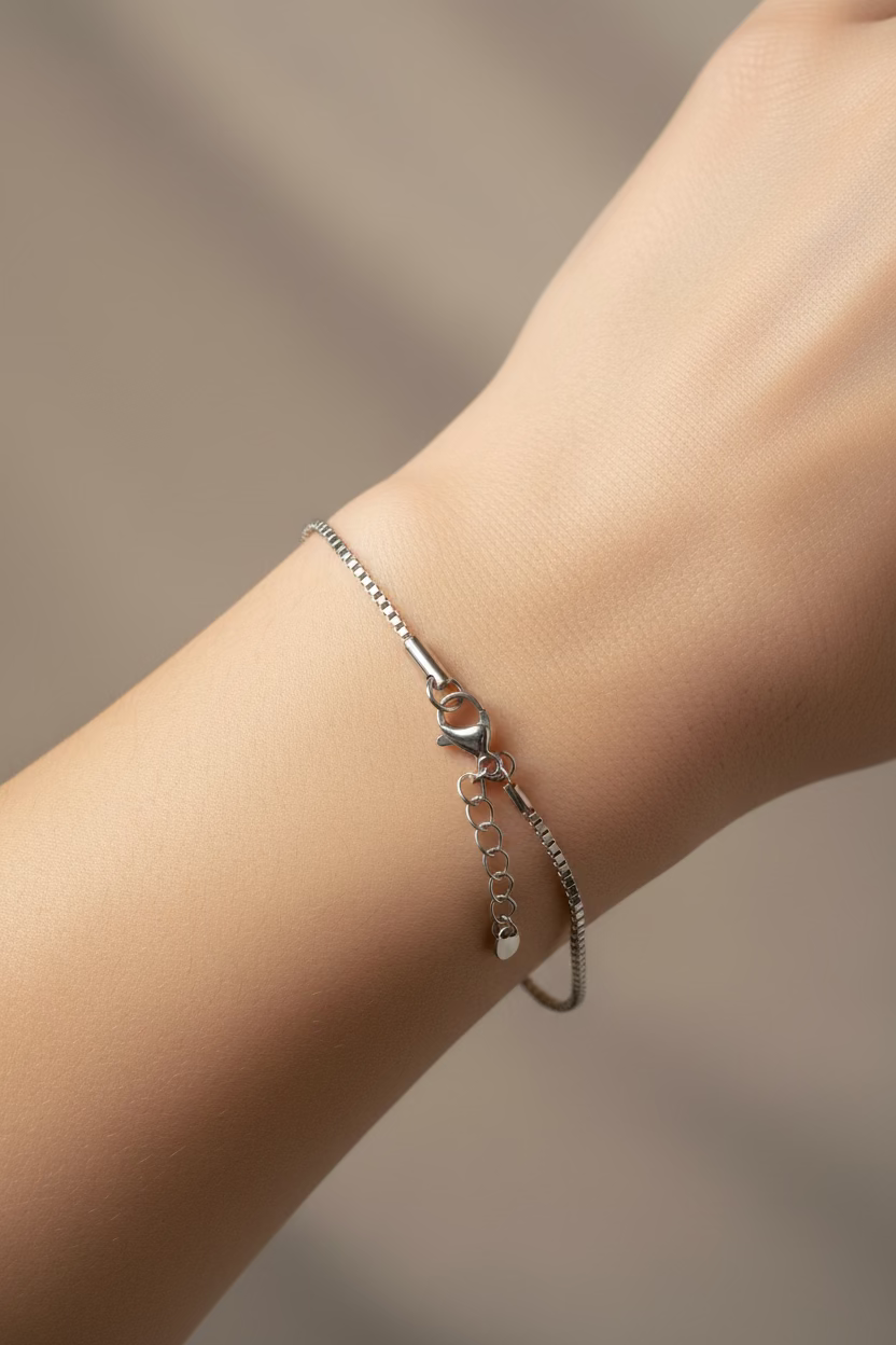 Silver chain necklace on a gray background