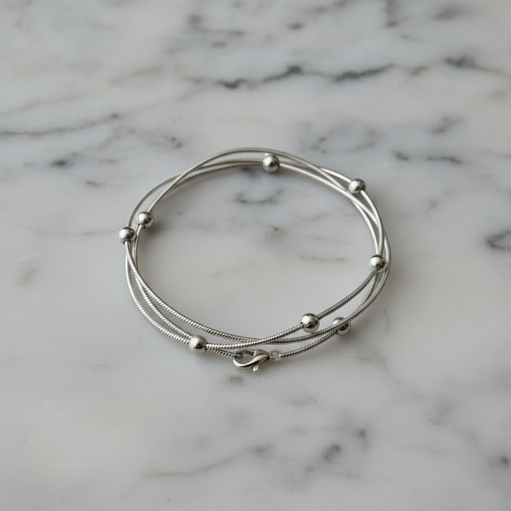 Silver bracelet on a flat white/grey marbled surface