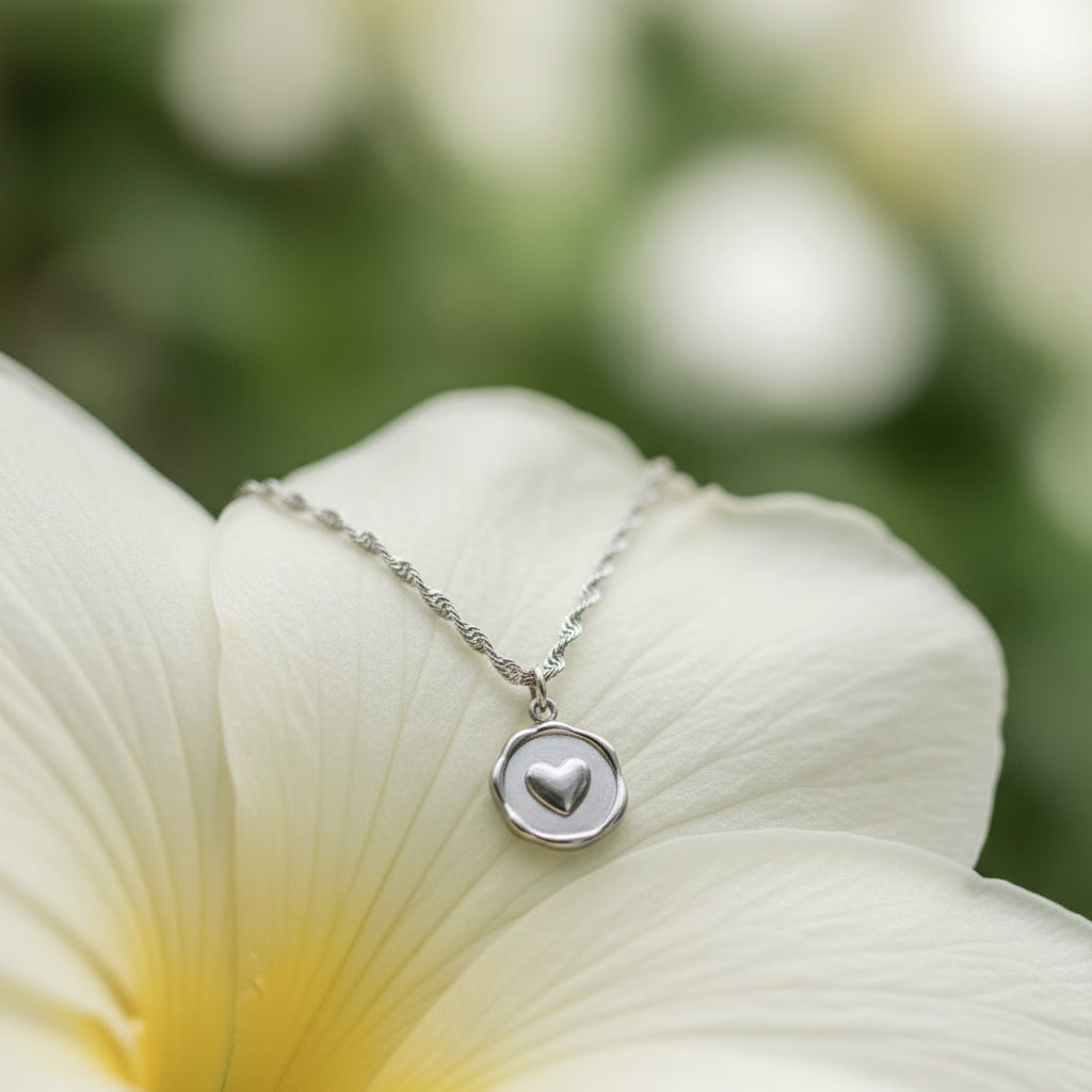 Necklace with a heart pendant on a large white flower