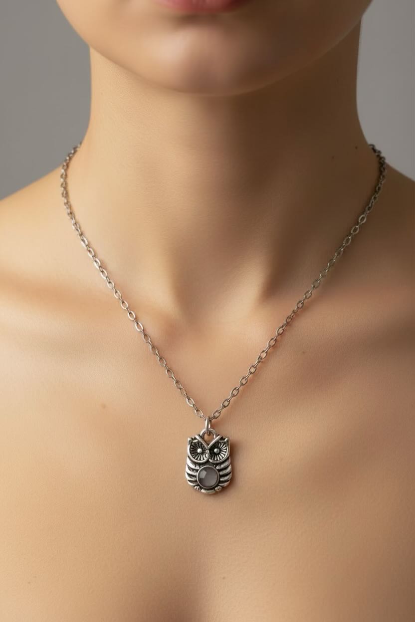 Silver owl pendant necklace on a mannequin neck