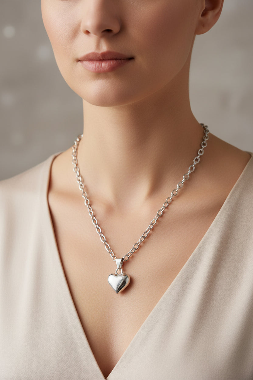 Silver chain necklace with a heart pendant on a model