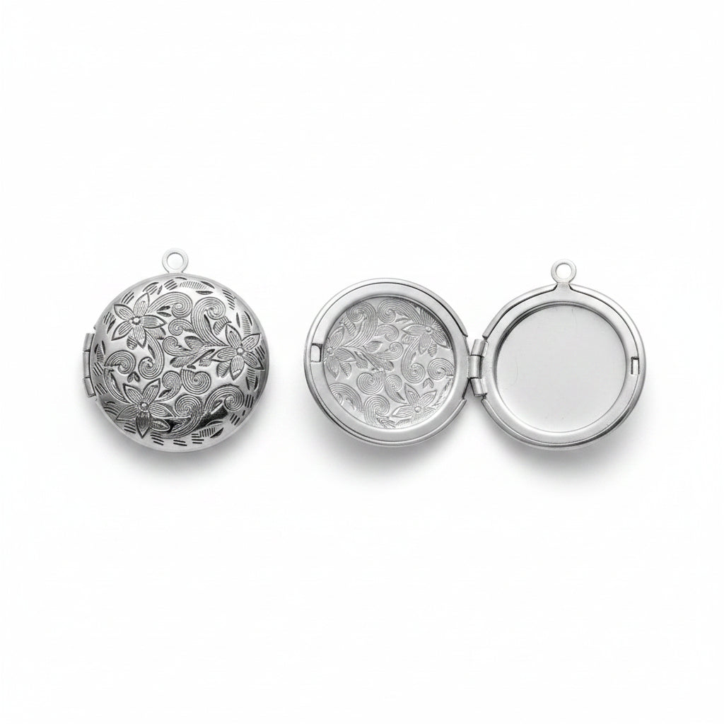 Silver round patterned locket with intricate design on a gray background