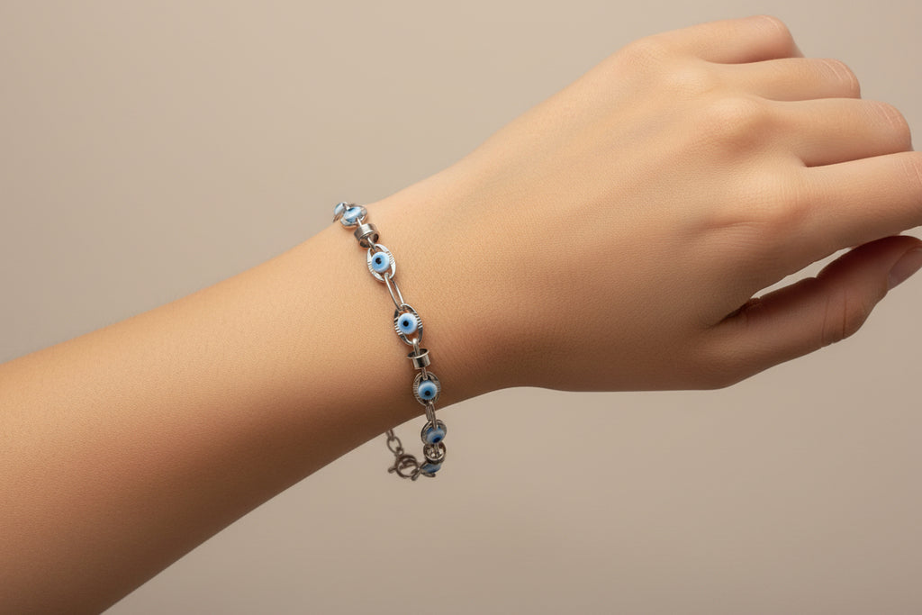 Silver bracelet with blue eye beads on a model's arm