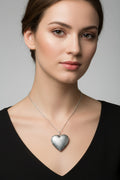 Silver heart-shaped pendant necklace on a model