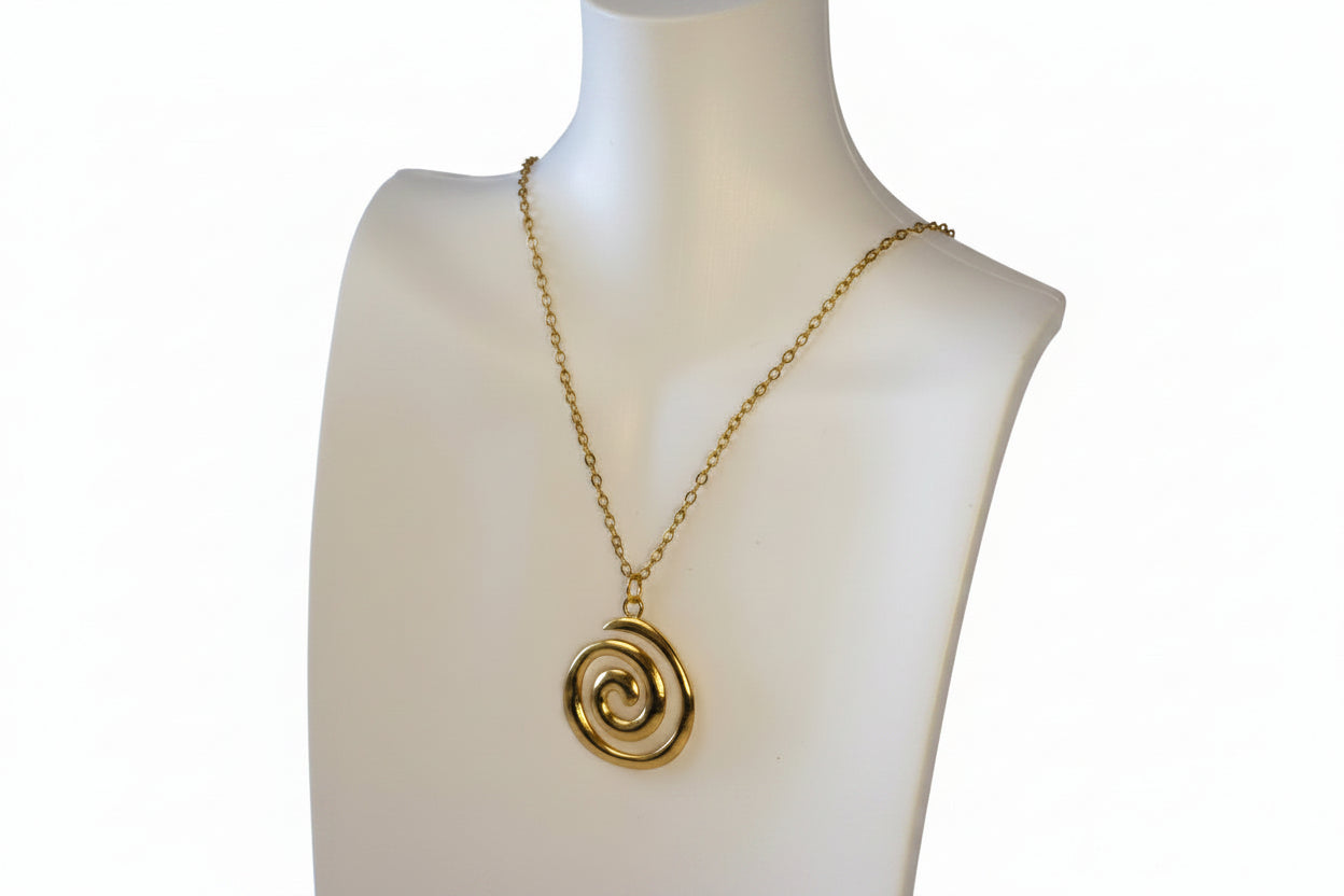 Gold spiral pendant necklace on a mannequin with a white background