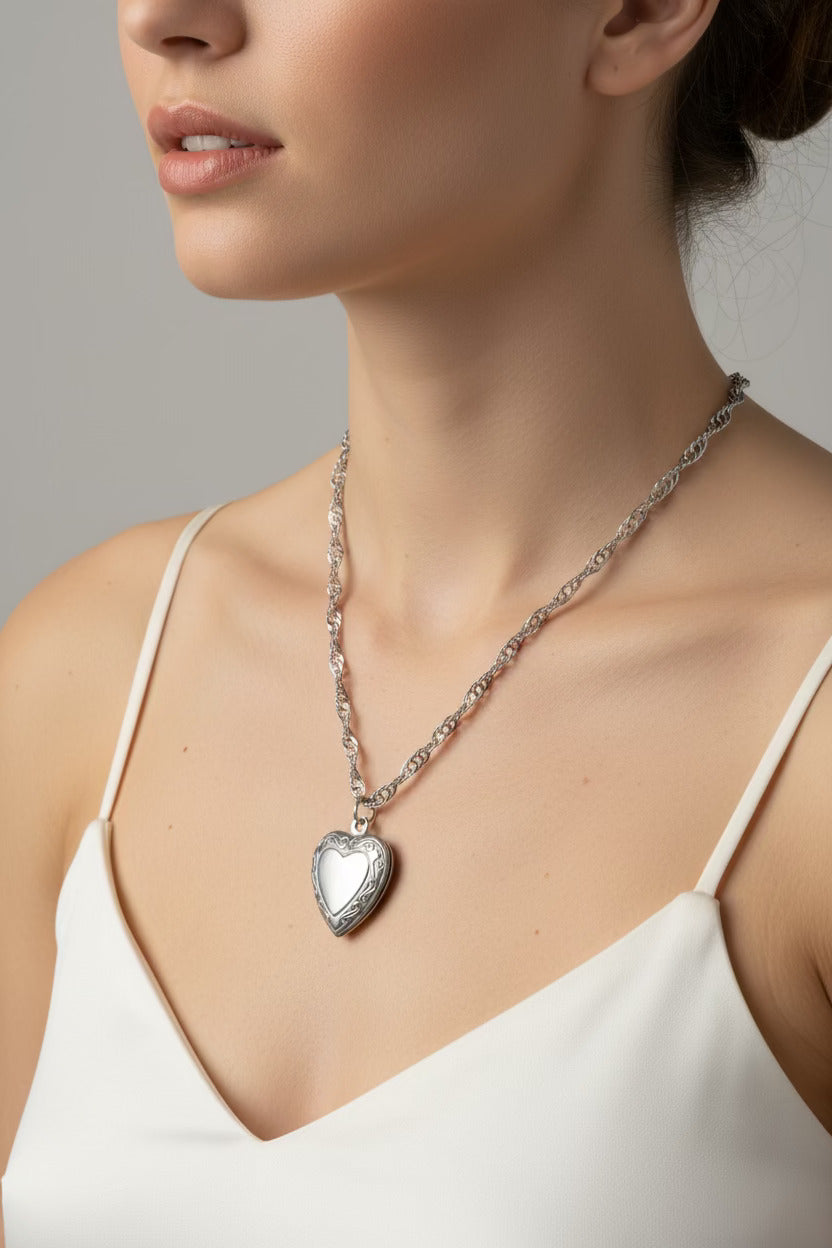Water wave necklace with a heart-shaped locket worn by a person 