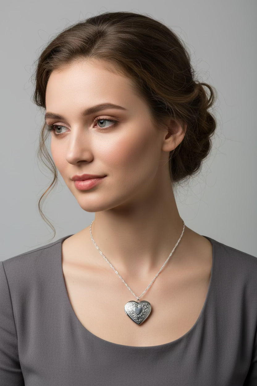 Woman wearing a silver heart locket-shaped necklace on a model