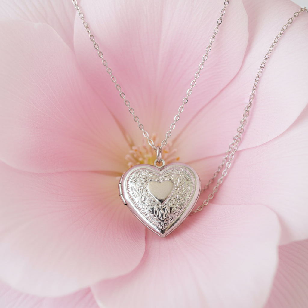 Silver heart-shaped locket necklace on a large petal