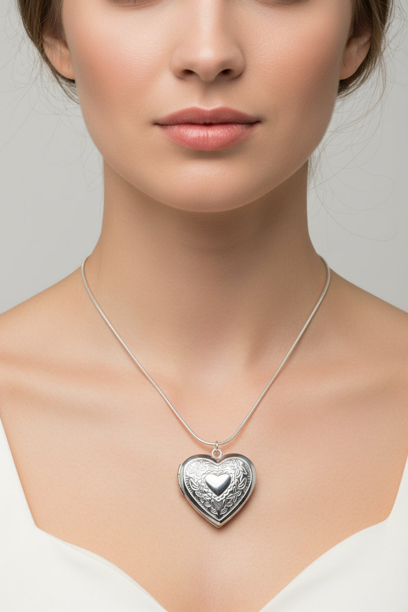 Silver heart-shaped locket necklace on a model