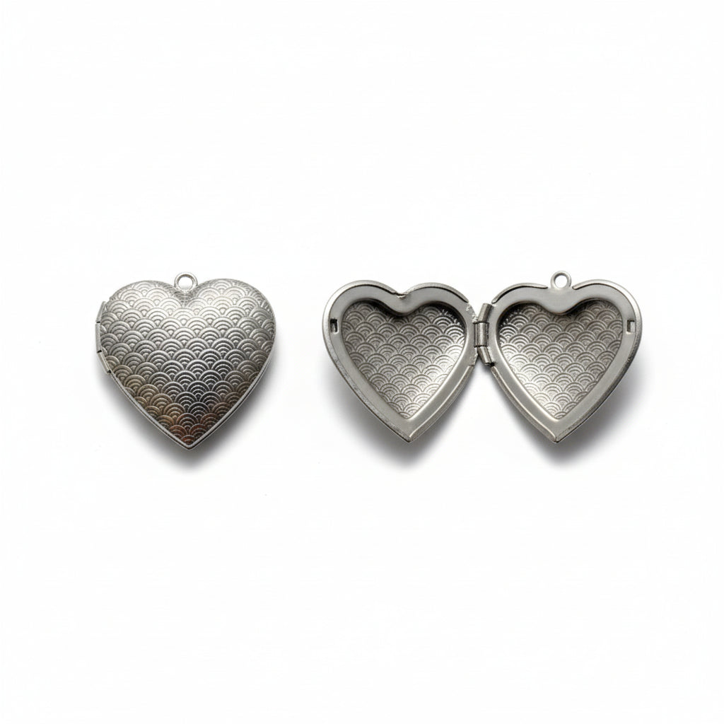 Heart-shaped metallic pendant on a light gray background