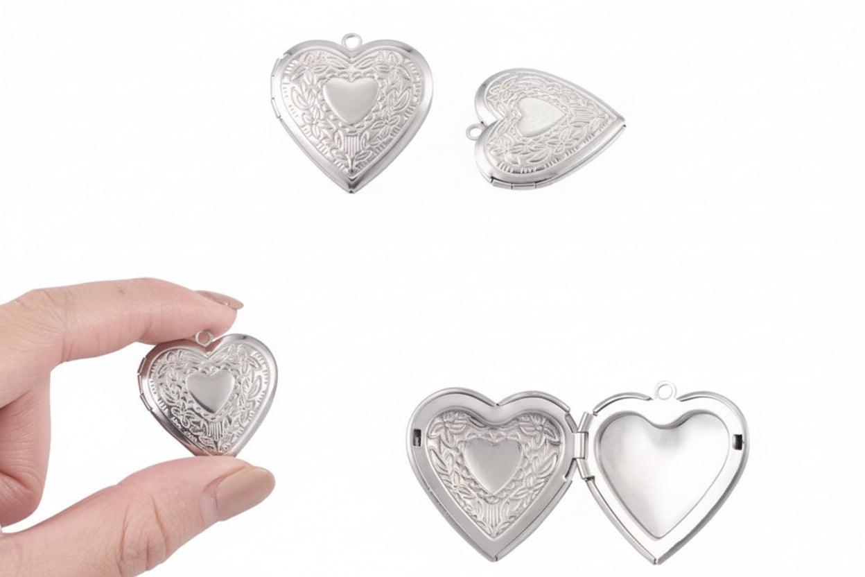 Heart-shaped silver locket with measurements and a hand holding it