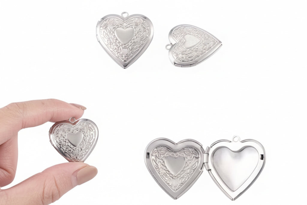 Silver heart-shaped photo locket held by a hand on a white background