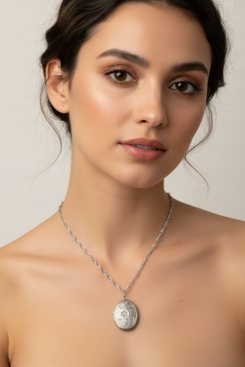 Model wearing a silver stainless steel water wave necklace & an oval flower design stainless steel locket