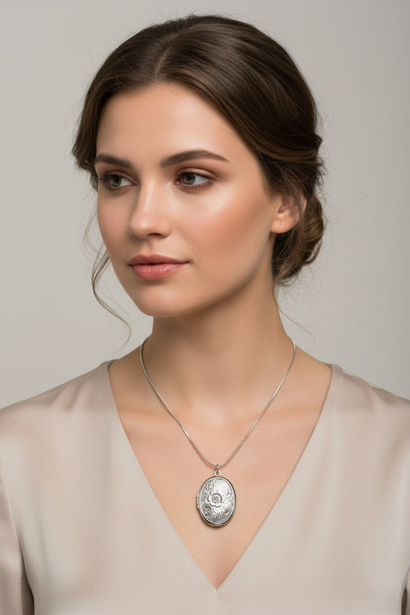 Silver sterling snake chain necklace with a stainless steel oval flower design locket on a model