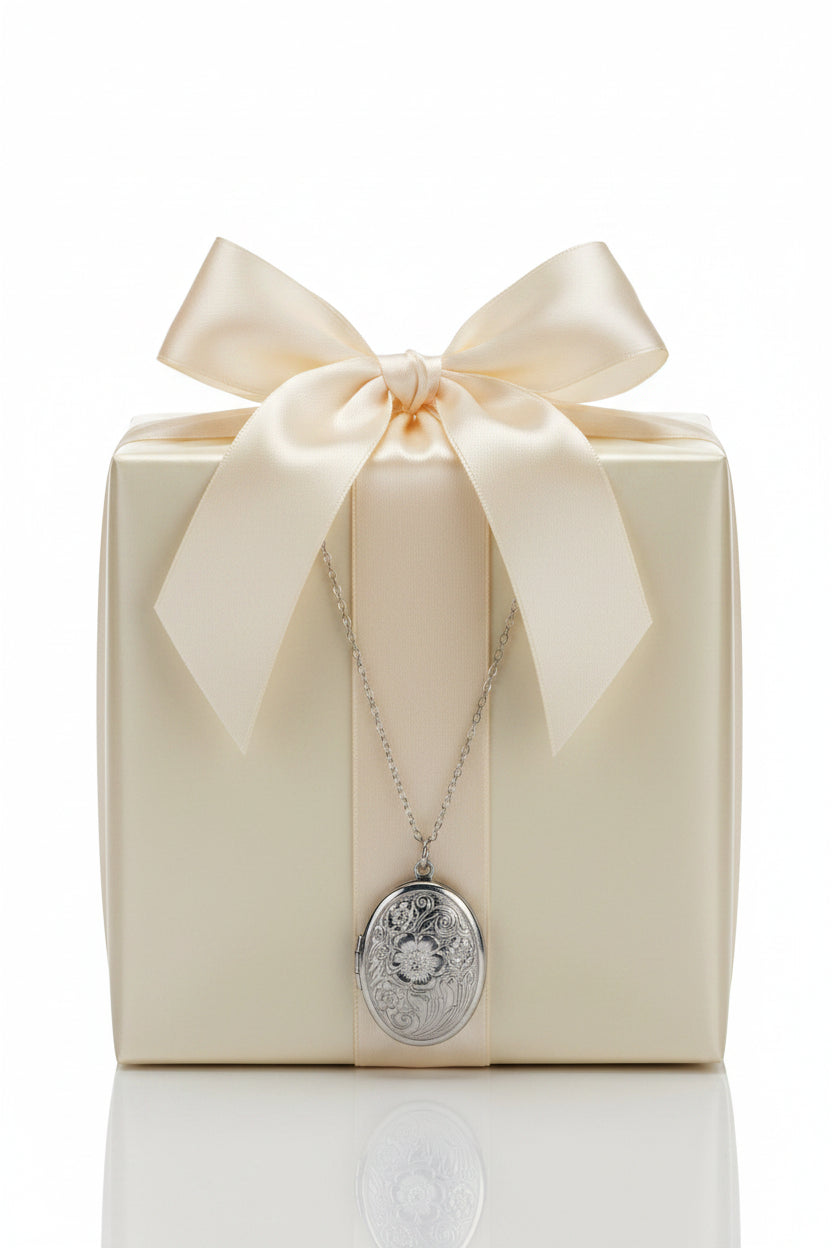 Silver stainless steel necklace with an oval flower design stainless steel locket on a large beige gift box